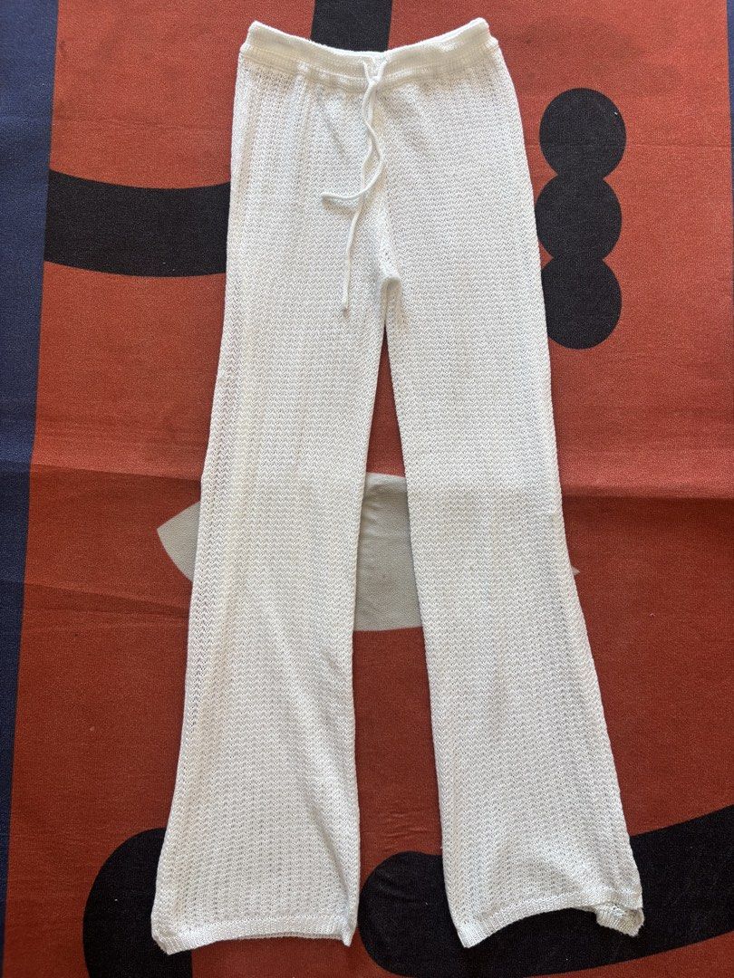 White Crochet Knit Flare Pants (Category: Other Bottoms) located in Alicia. Submitted by thriftbagph (Listing ID 1460660019, Image 1). Description: - White crochet knit pants - Flare leg style - Adjustable drawstring waist - Lightweight and breathable fabric - Ideal for beach or casual outfits - Estimated size medium (please check tag for exact sizing).
