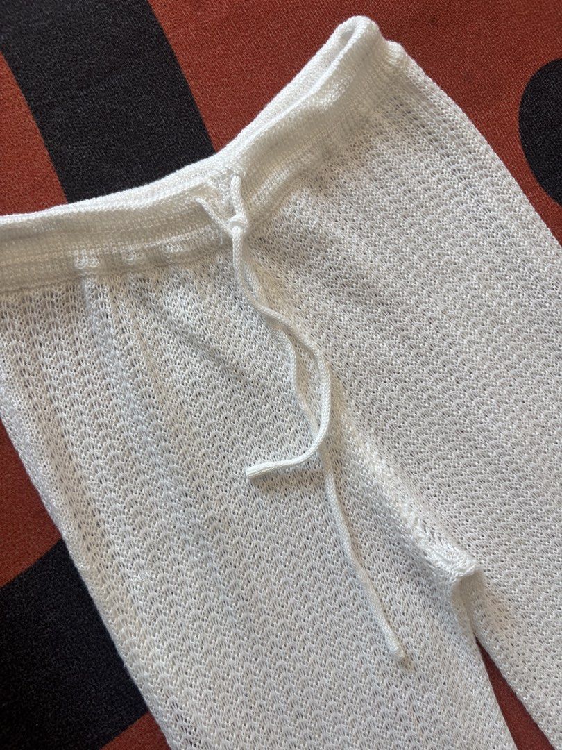White Crochet Knit Flare Pants (Category: Other Bottoms) located in Alicia. Submitted by thriftbagph (Listing ID 1460660019, Image 2). Description: - White crochet knit pants - Flare leg style - Adjustable drawstring waist - Lightweight and breathable fabric - Ideal for beach or casual outfits - Estimated size medium (please check tag for exact sizing).