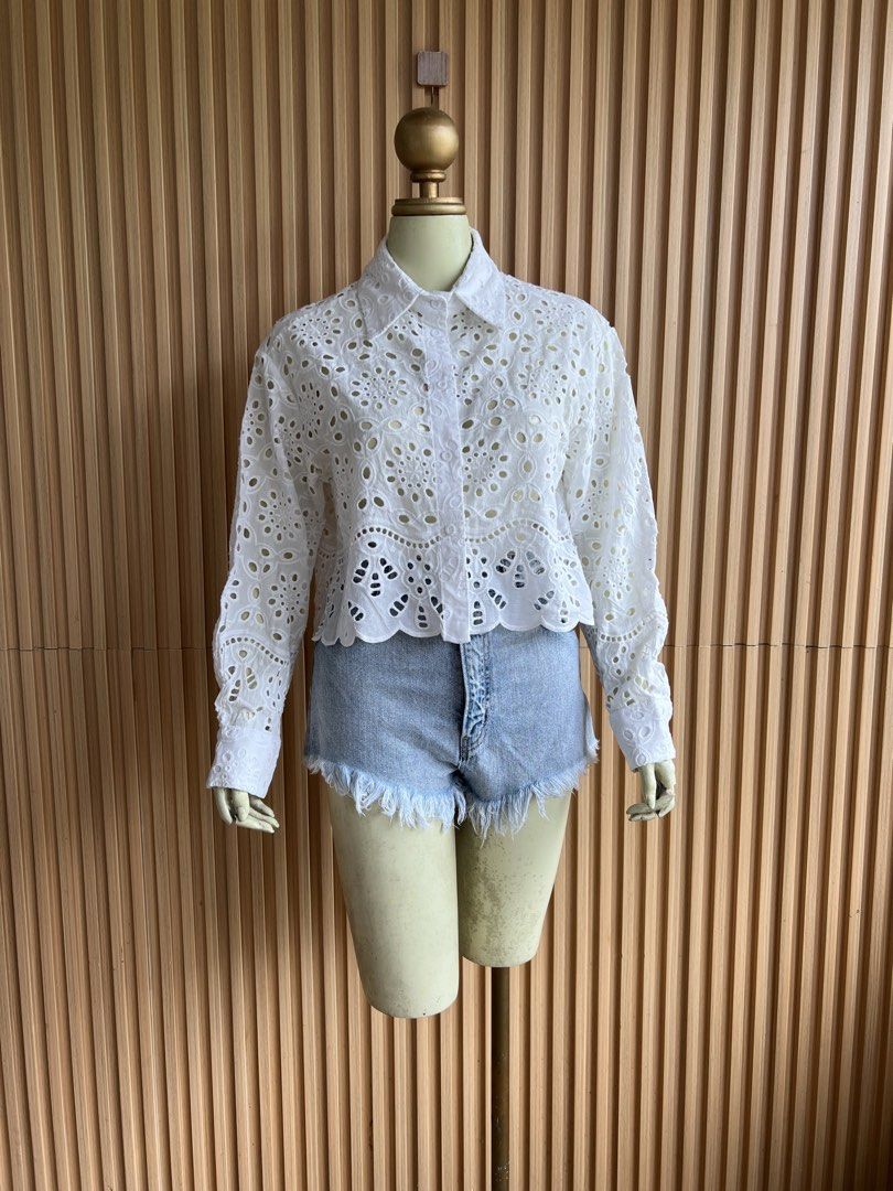 White Eyelet Cropped Button-Up Shirt (Category: Shirts) located in Lipa City. Submitted by thyra06 (Listing ID 1460642168, Image 1). Description: - White cropped shirt - Intricate eyelet details all over - Classic collar and button-up front - Long sleeves with button cuffs - Feminine scalloped hemline - Versatile: pairs well with denim shorts or skirts - Ideal for sunny weather.