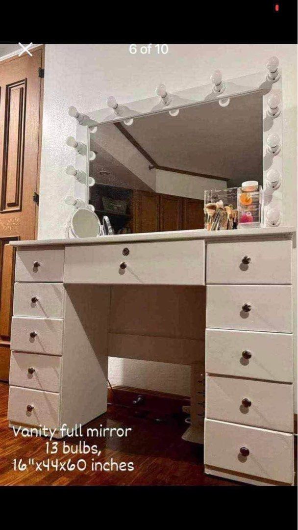 White Vanity Table with Lighted Mirror and Stool (Category: Tables & Sets) located in Manila. Submitted by jmd2197 (Listing ID 1460520097, Image 2). Description: - White vanity table - Large mirror with 13 bright bulbs - Multiple storage drawers on both sides and center - Comes with a matching stool - Ideal for makeup application and getting ready RFS: Will switch to a smaller mirror. Price is still negotiable. .