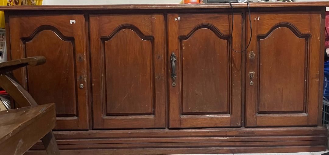Wooden Cabinet with 4 Doors (Category: Shelves, Cabinets & Racks) located in Caloocan City. Submitted by tintinmp155338 (Listing ID 1460565362, Image 1). Description: ✔️ Made of Narra wood ✔️ Sturdy and heavy construction ✔️ Classic vintage-style design with carved panel doors ✔️ 4-door cabinet with spacious storage ✔️ Perfect for dining area, living room, or display/storage ✔️ Beautiful natural wood finish ✔️ Pre-loved – with visible scratches a