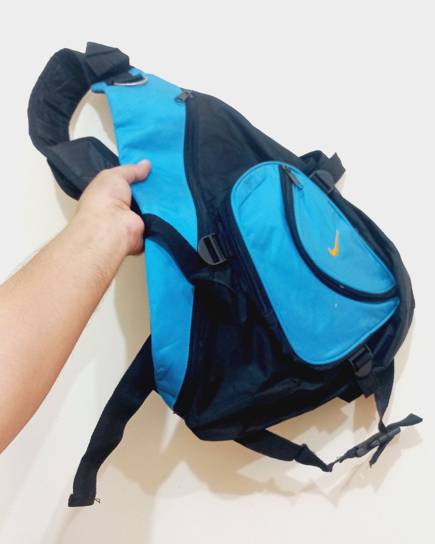 Y2k Nike Blue and Black Sling Bag (Category: Sling Bags) located in Cebu City. Submitted by MrLiks_123 (Listing ID 1460509178, Image 2). Description: Y2K Nike single-strap sling crossbody bag featuring a striking black and bright blue colorway with a contrast orange embroidered Swoosh logo .