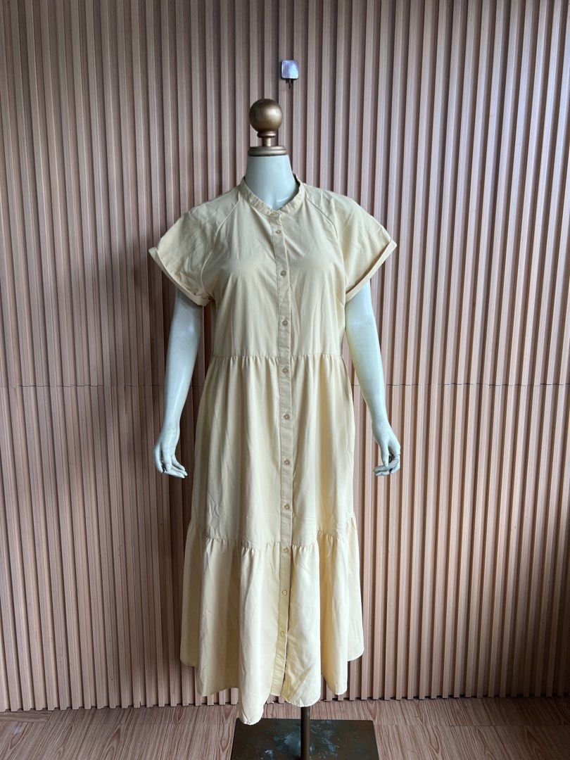 Yellow Button-Up Tiered Midi Dress (Category: Dresses) located in Lipa City. Submitted by thyra06 (Listing ID 1460651385, Image 2). Description: - Light yellow midi dress - Button-up front with mandarin collar - Short sleeves with rolled cuffs - Tiered skirt design - Comfortable and casual - Perfect for everyday wear.
