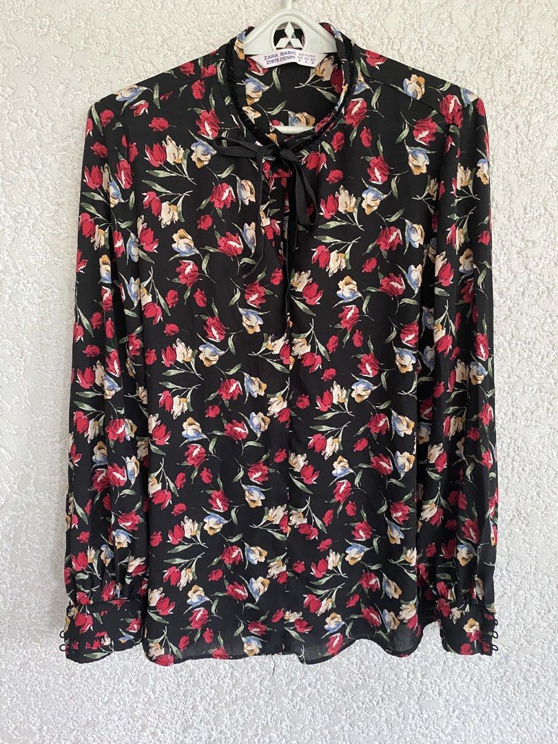 Zara Basic Floral Print Blouse with Tie Neck (Category: Blouses) located in Paranaque City. Submitted by dessells_ (Listing ID 1460522219, Image 1). Description: - Vibrant floral print on black fabric - Elegant tie-neck detail - Classic button cuffs - Proudly made in Spain - Perfect for pairing with jeans or skirts - Easily dressed up or down for any occasion - Gcash/ J&T - 280+SF.