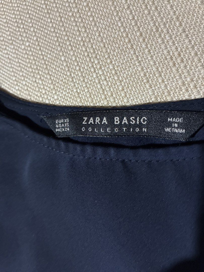 Zara Basic Navy Blue Long Sleeve Top with Red & White Stripes (Category: Blouses) located in Pasig City. Submitted by slr1949 (Listing ID 1460632219, Image 2). Description: - Zara Basic navy blue long sleeve top - Size XS (estimated) - Bell sleeves with red and white stripe detailing on arms - Versatile for casual or dressed-up looks.