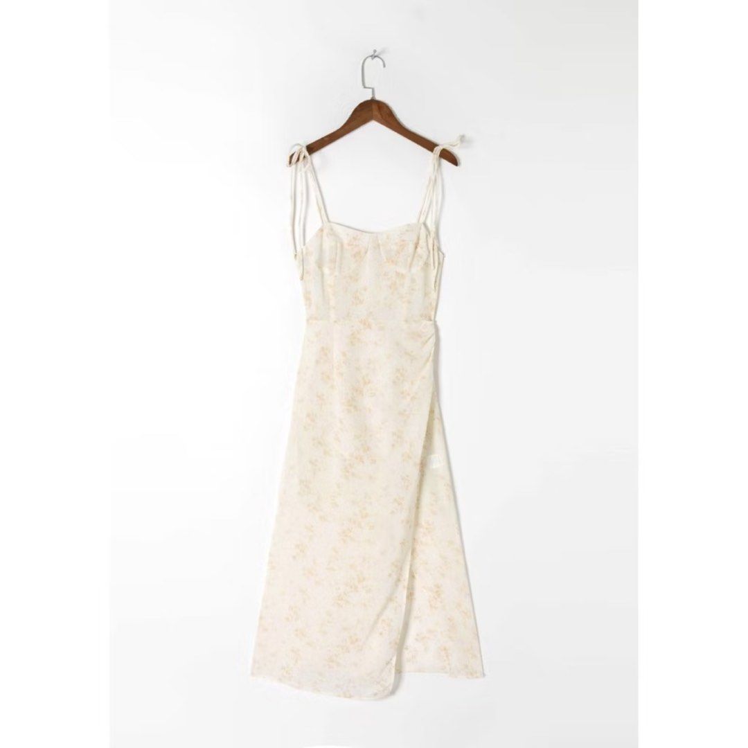Zara ins Dress (Category: Dresses) located in Manila. Submitted by cluttersbya (Listing ID 1460635927, Image 1). Description: - Cream midi dress with a delicate floral print bought online Zara inspired/H&M/Mango/Ever New/Love Bonito - Adjustable tie straps for a customizable fit - Smocked back ensures comfort and a snug feel - Flattering wrap-style skirt - Lightweight fabric, ideal for sunny days - Versatile for casual or dressed-up occasions.