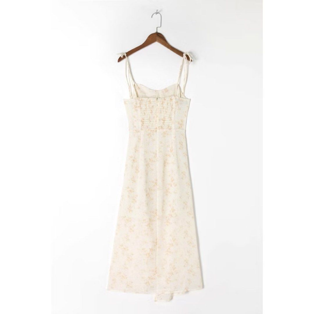 Zara ins Dress (Category: Dresses) located in Manila. Submitted by cluttersbya (Listing ID 1460635927, Image 2). Description: - Cream midi dress with a delicate floral print bought online Zara inspired/H&M/Mango/Ever New/Love Bonito - Adjustable tie straps for a customizable fit - Smocked back ensures comfort and a snug feel - Flattering wrap-style skirt - Lightweight fabric, ideal for sunny days - Versatile for casual or dressed-up occasions.
