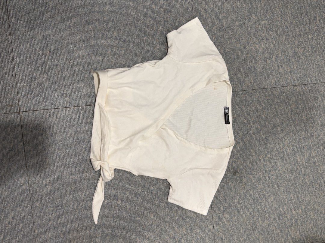 Zara White Ribbed Wrap Top with Tie (Category: Blouses) located in Cavite. Submitted by icy______ (Listing ID 1460690921, Image 1). Description: - White ribbed wrap top from Zara - Short sleeves with side tie detail - Textured fabric - Perfect for dressing up or down.